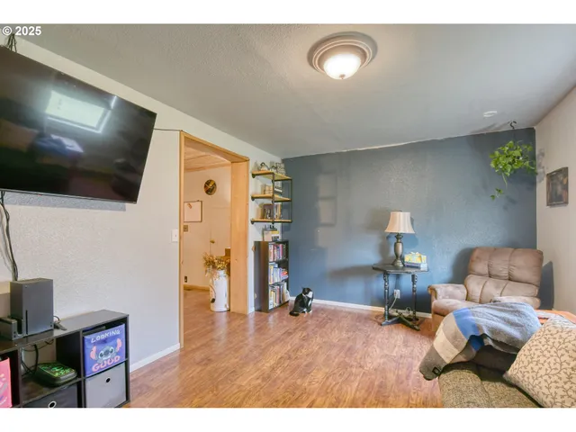 a bedroom with furniture and a flat screen tv