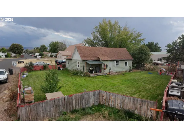a yellow house with swimming pool in front of it
