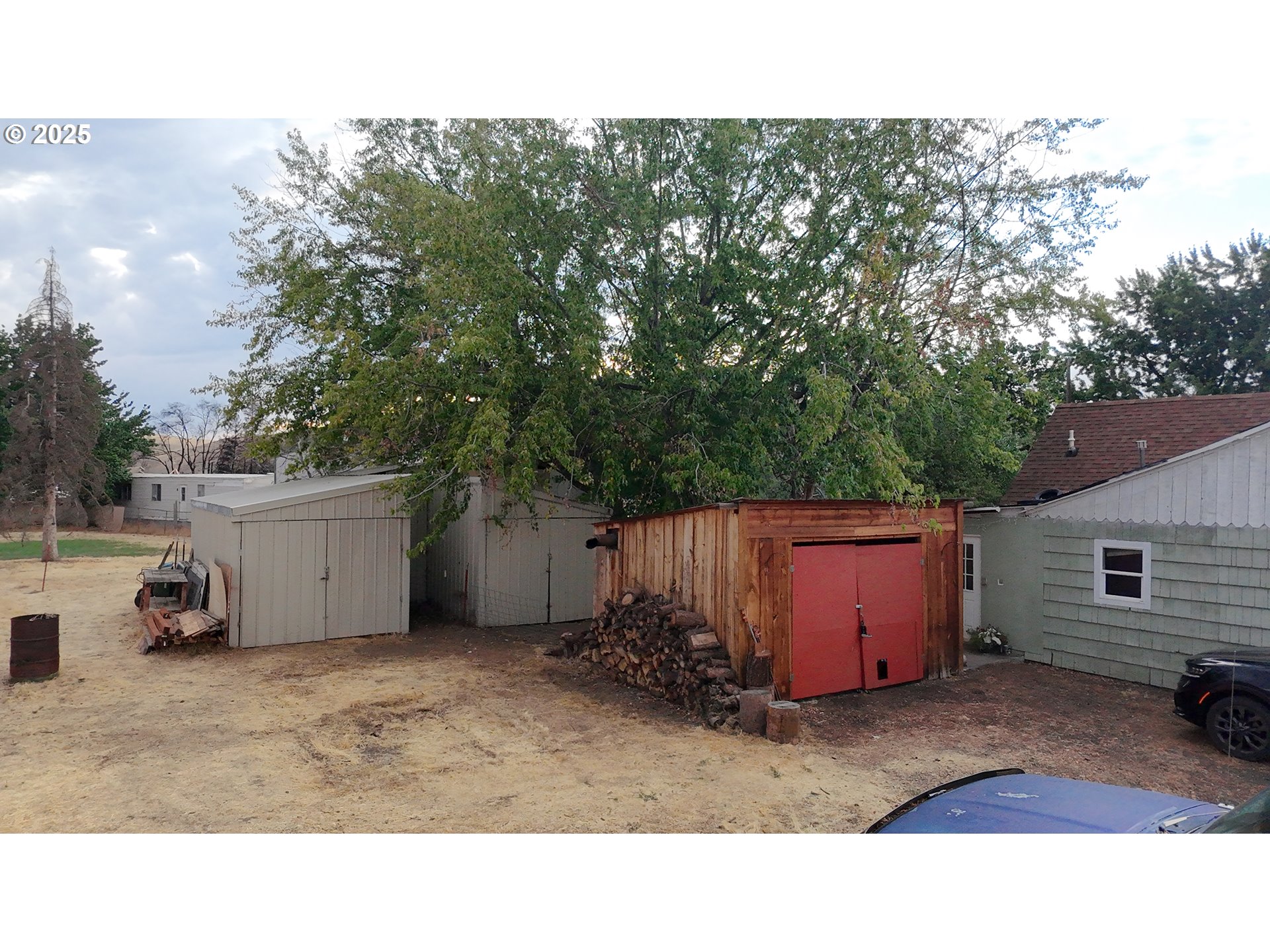 559 Southwest Cedar Street Pilot Rock, OR 97868 - Photo 5 of 42 a backyard of a house with barbeque oven and wooden fence