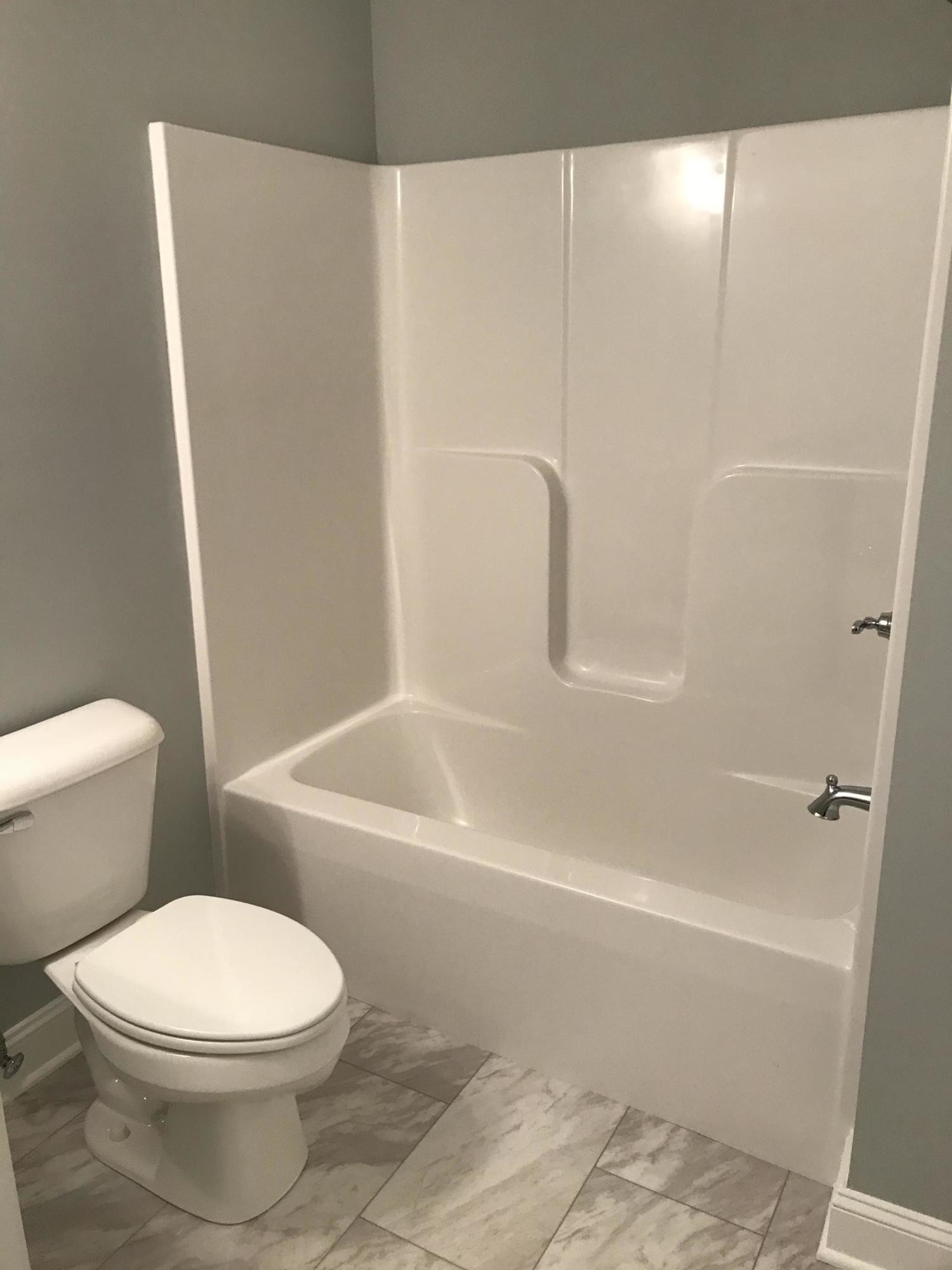 127 West Lincoln Road Oak Ridge, TN 37830 - Photo 21 of 32 a white toilet sitting next to a bath tub