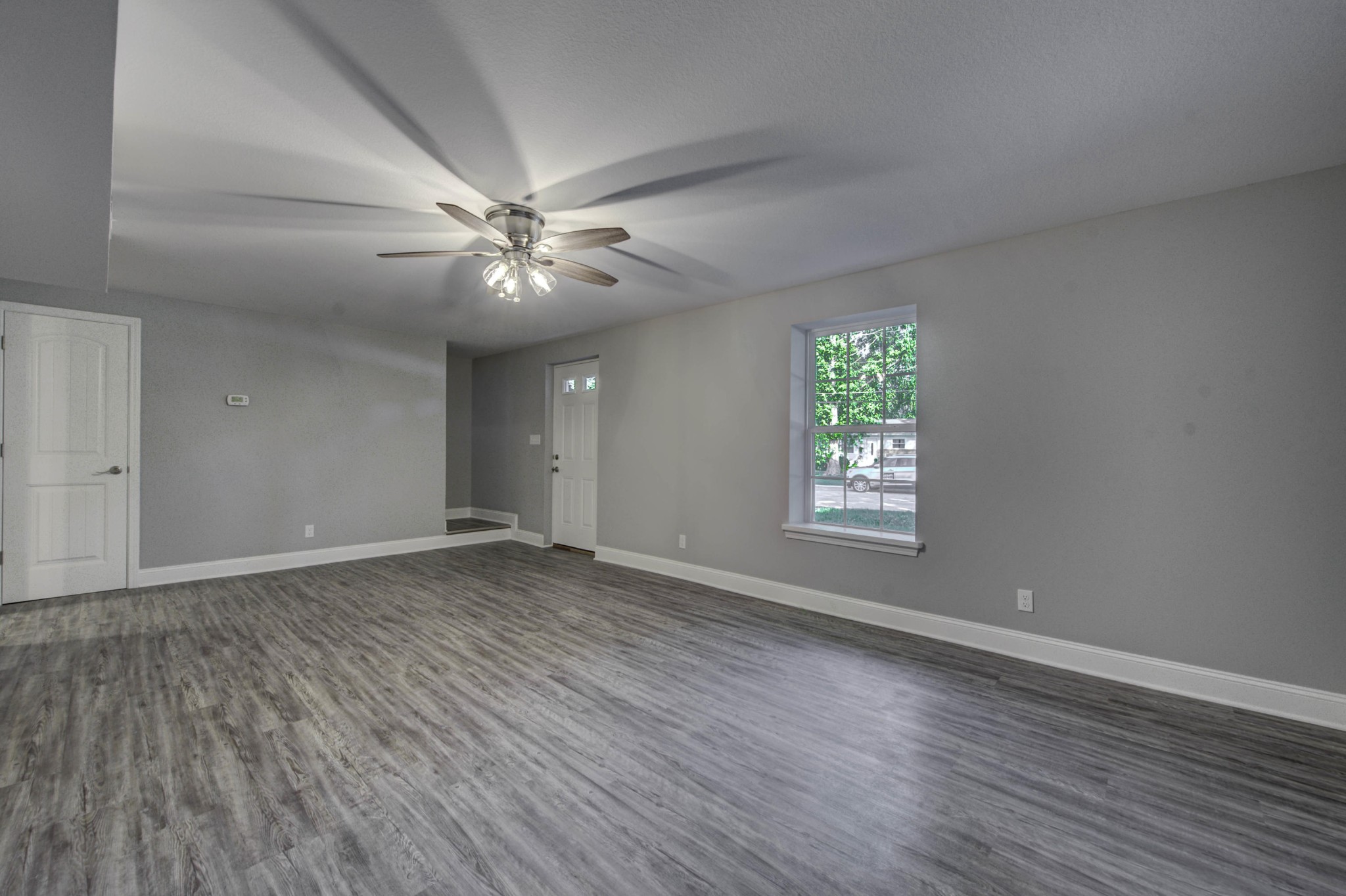 127 West Lincoln Road Oak Ridge, TN 37830 - Photo 24 of 32 a view of an empty room with window and wooden floor