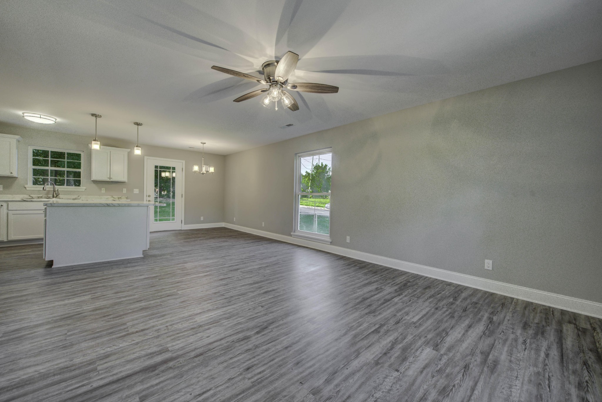 127 West Lincoln Road Oak Ridge, TN 37830 - Photo 3 of 32 a view of an empty room with wooden floor and a window