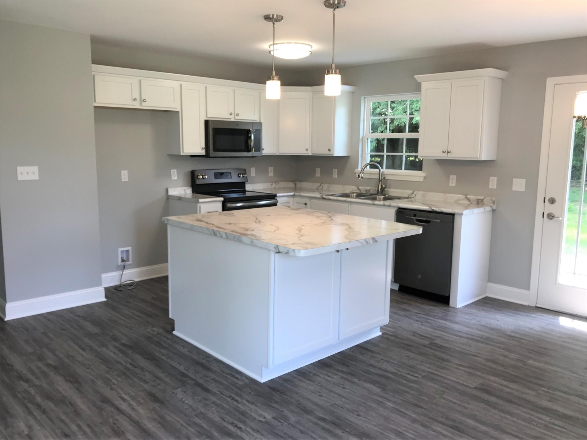 127 West Lincoln Road Oak Ridge, TN 37830 - Photo 5 of 32 a kitchen with stainless steel appliances granite countertop a stove a sink and a microwave