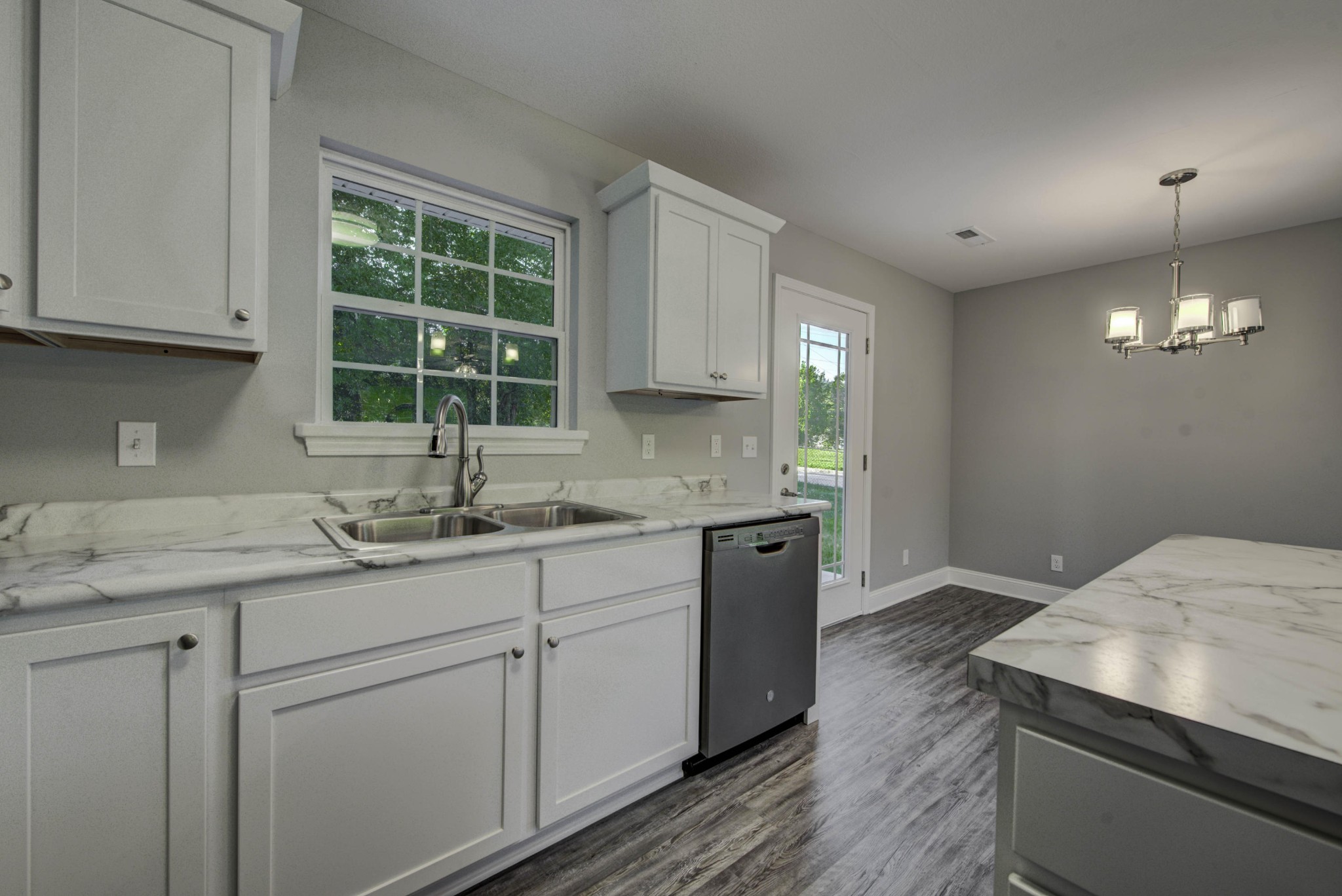 127 West Lincoln Road Oak Ridge, TN 37830 - Photo 6 of 32 a kitchen with sink cabinets and window