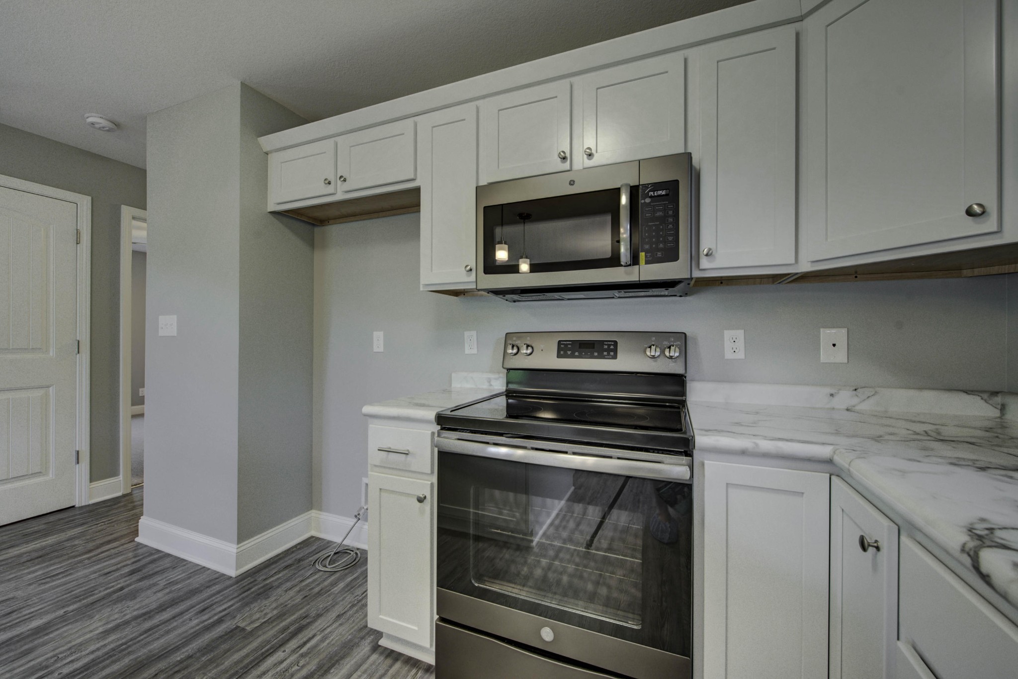 127 West Lincoln Road Oak Ridge, TN 37830 - Photo 9 of 32 a kitchen with white cabinets and stainless steel appliances
