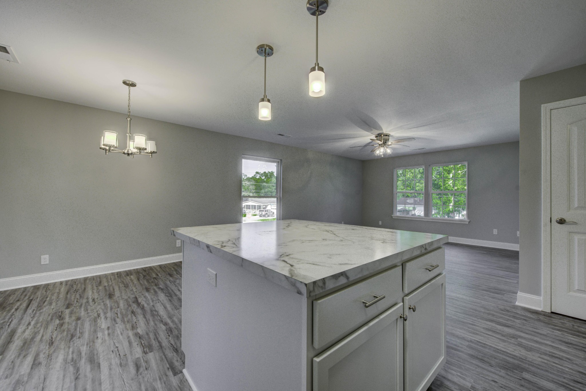 127 West Lincoln Road Oak Ridge, TN 37830 - Photo 10 of 32 a kitchen with a sink chandelier and wooden floor