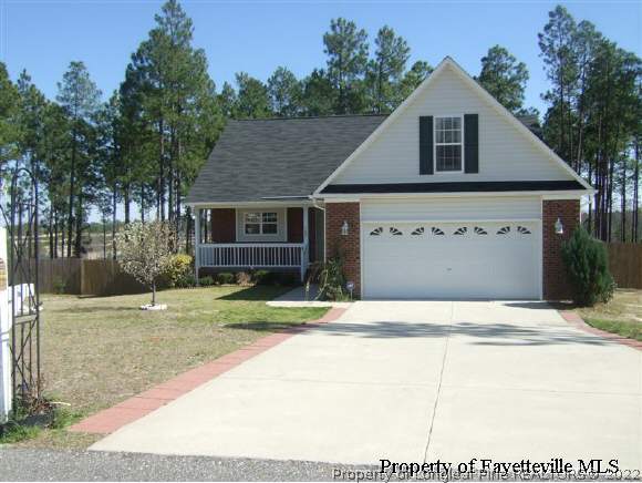 122 Chesapeake Road Cameron, NC 28326 - Photo 1 of 10 a front view of a house with a yard