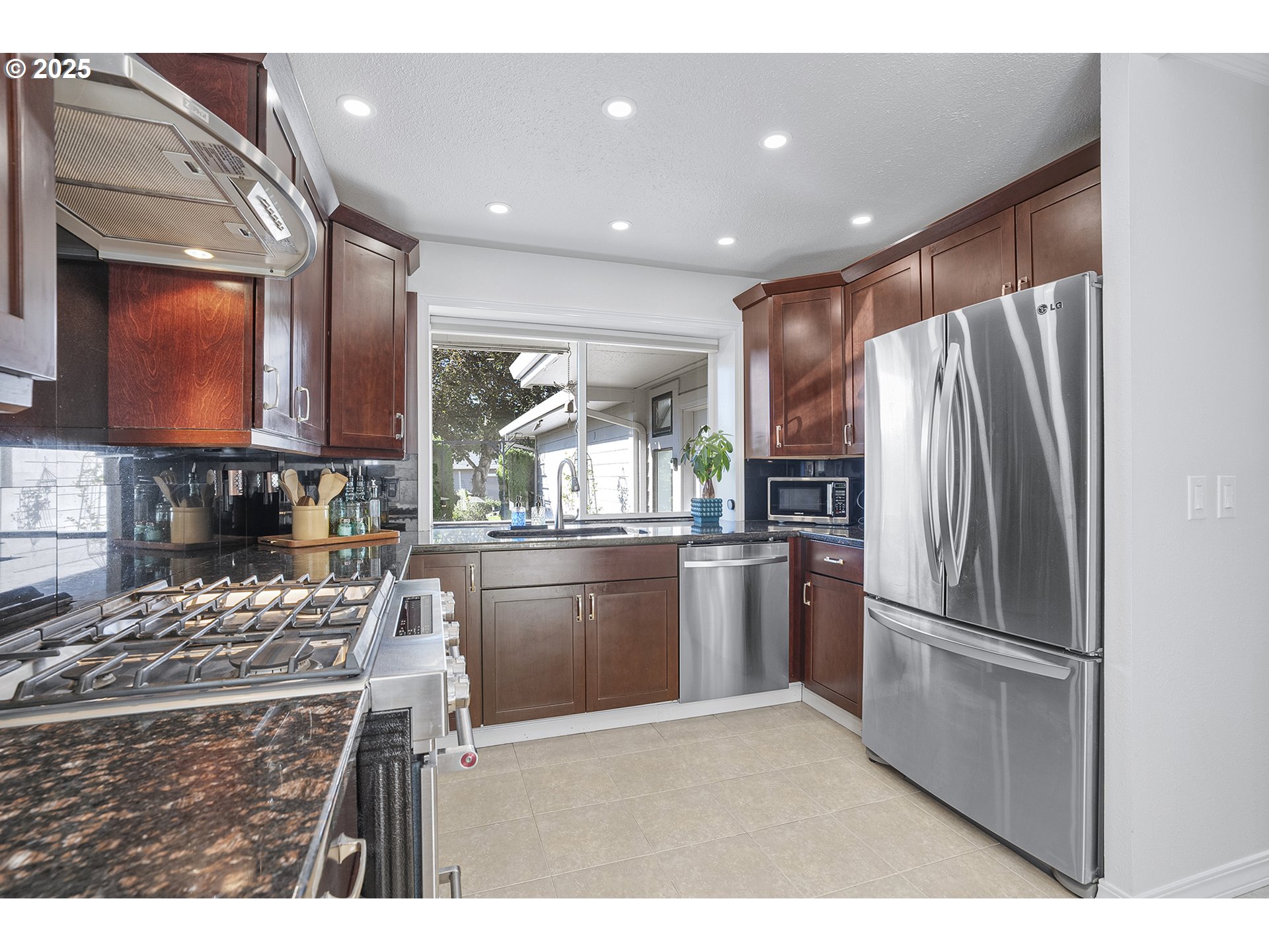 32215 Southwest East Lake Point Wilsonville, OR 97070 - Photo 11 of 47 a kitchen with kitchen island granite countertop a refrigerator stove top oven and sink
