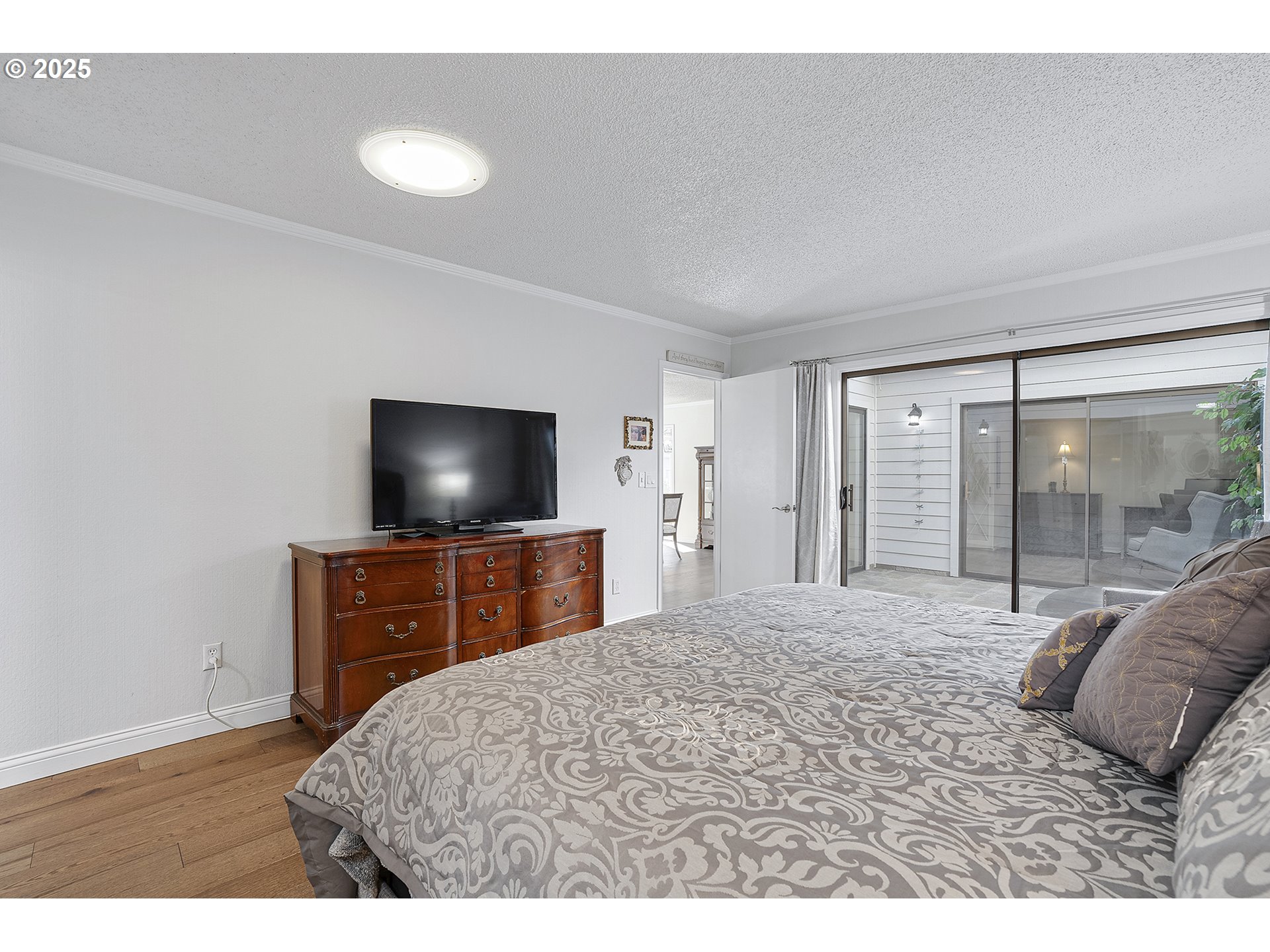32215 Southwest East Lake Point Wilsonville, OR 97070 - Photo 32 of 47 a bedroom with a bed and a flat screen tv