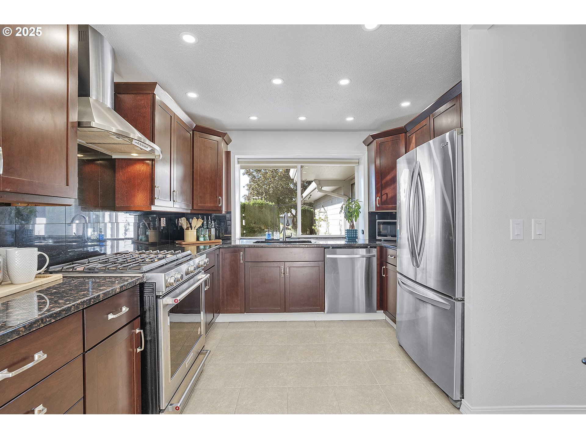 32215 Southwest East Lake Point Wilsonville, OR 97070 - Photo 10 of 47 a kitchen with stainless steel appliances granite countertop a refrigerator a stove a sink and a microwave