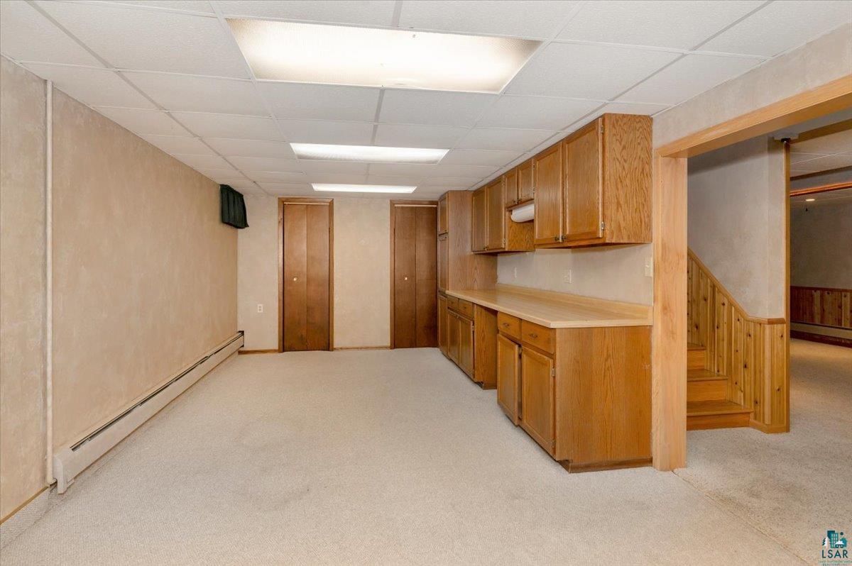5219 West Arrowhead Road Hermantown, MN 55811 - Photo 24 of 35 Kitchen with a baseboard radiator, a paneled ceiling, and light colored carpet