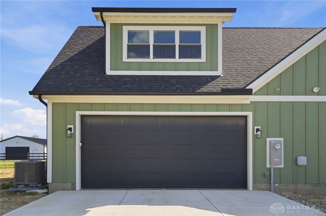 9364 Kenrick Road Dayton, OH 45458 - Photo 54 of 62 This newly constructed property features an attached garage with a modern exterior design.