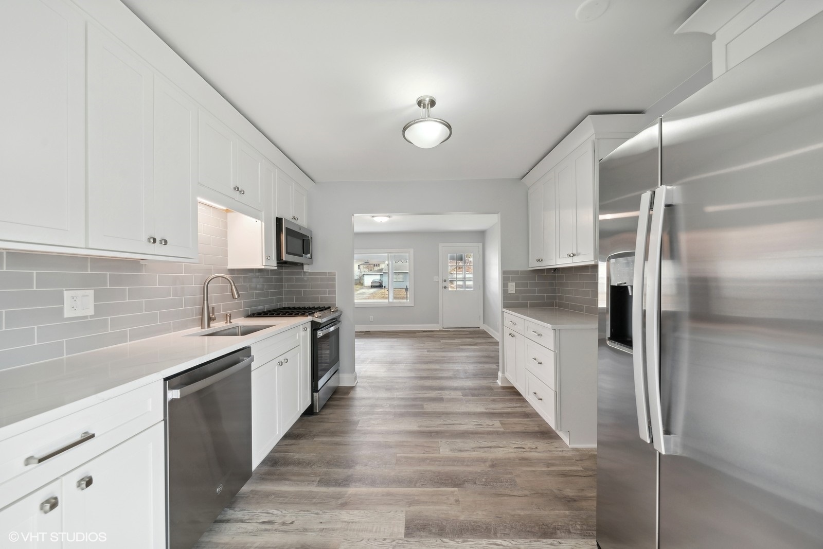 129 Springleaf Drive Bolingbrook, IL 60440 - Photo 2 of 14 a large kitchen with a center island wooden floor stainless steel appliances and cabinets