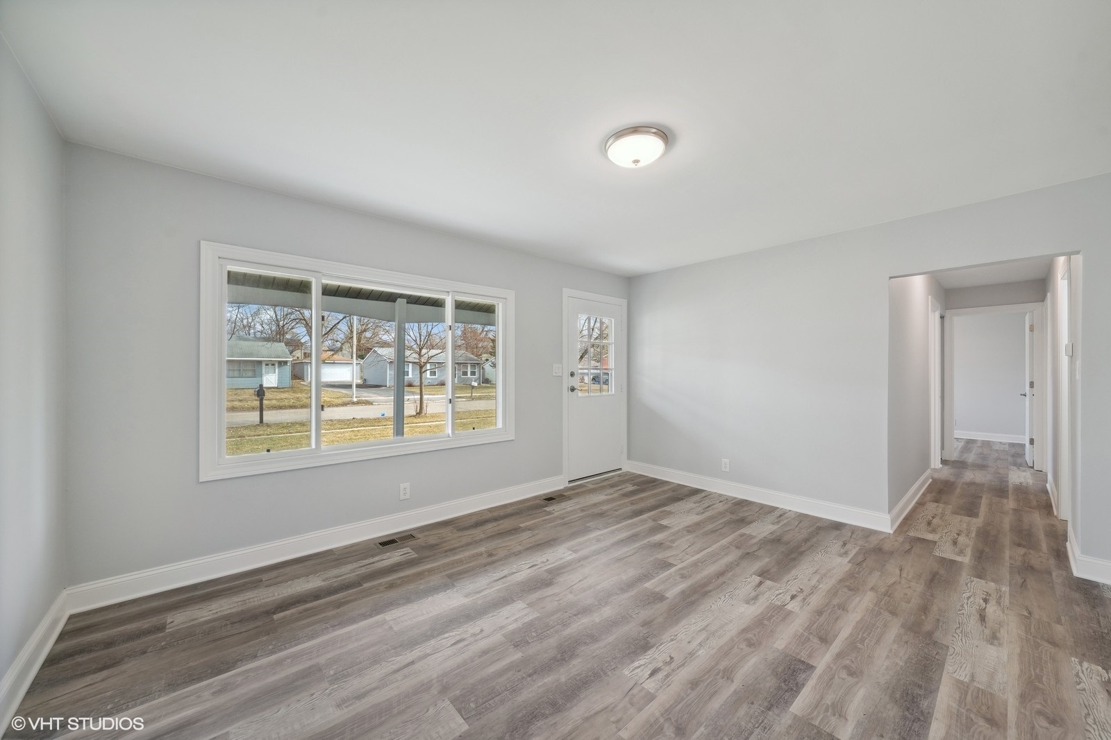 129 Springleaf Drive Bolingbrook, IL 60440 - Photo 3 of 14 a view of an empty room with wooden floor and a window