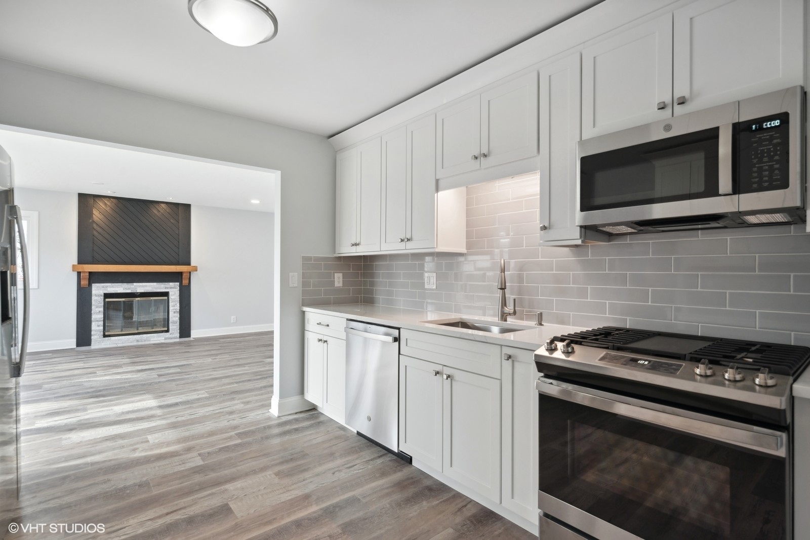 129 Springleaf Drive Bolingbrook, IL 60440 - Photo 5 of 14 a kitchen with stainless steel appliances a stove microwave and sink