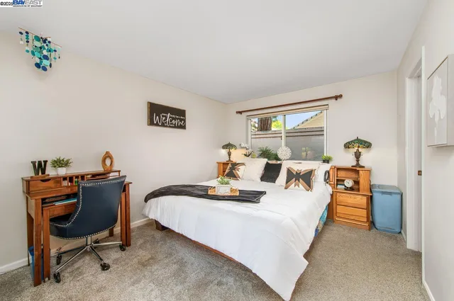 a bedroom with furniture and a window