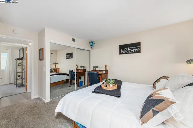 a bedroom with a bed and a table chair