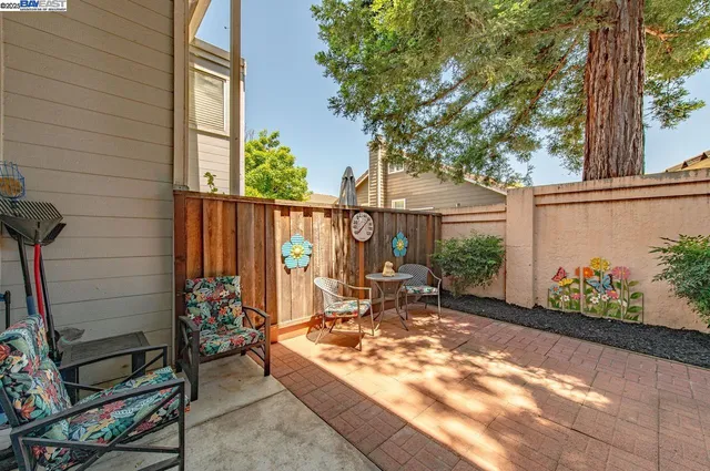 a view of a chair and table in the patio
