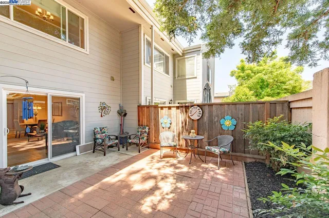 a backyard of a house with yard and outdoor seating