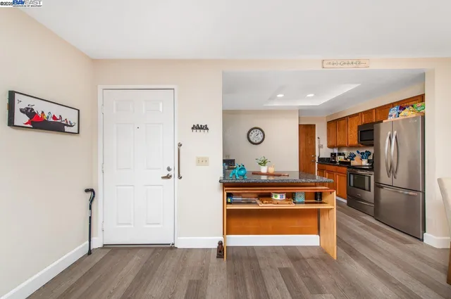 a kitchen with a refrigerator and a stove top oven