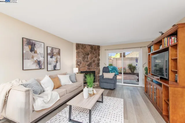a living room with fireplace furniture and a flat screen tv