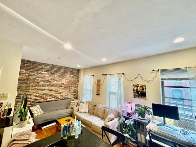 17 Thacher Street, Unit 3 Boston, MA 02113 - Photo 5 of 24 a living room with furniture and a large window