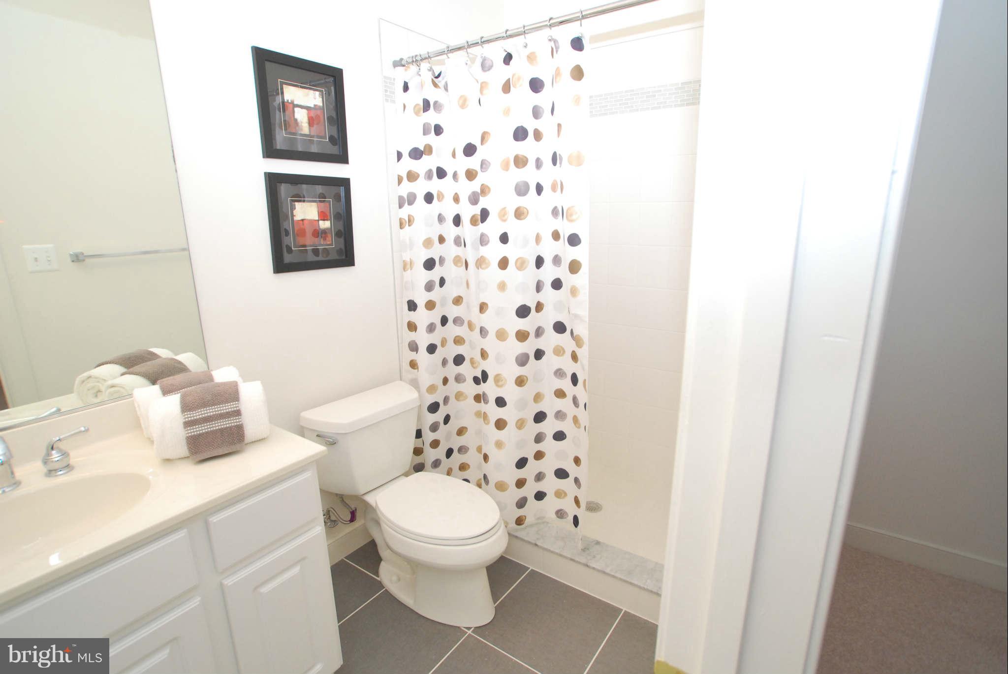 25115 Vista Ridge Road Laytonsville, MD 20882 - Photo 22 of 24 a white toilet sitting next to a shower curtain