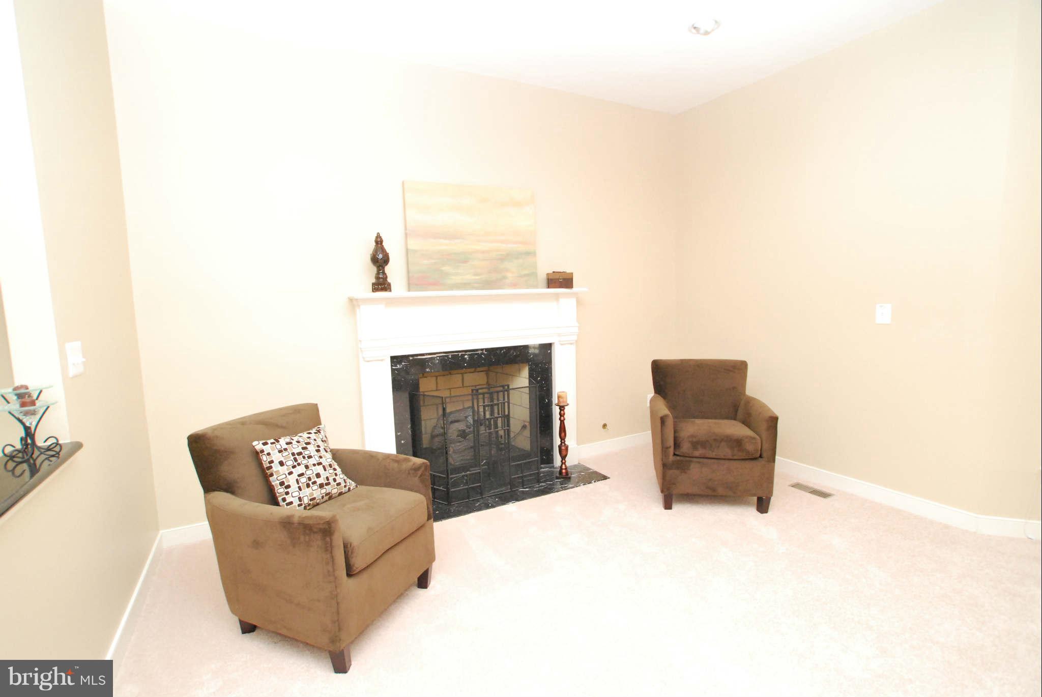 25115 Vista Ridge Road Laytonsville, MD 20882 - Photo 8 of 24 a living room with furniture and a fireplace