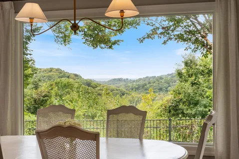 a view of a balcony with chair and table