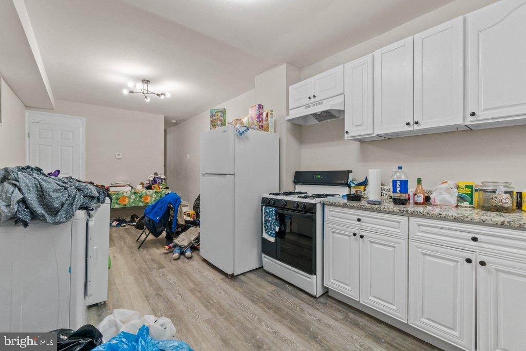 1913 Christian Street Baltimore, MD 21223 - Photo 10 of 18 Cluttered kitchen with modern cabinetry.