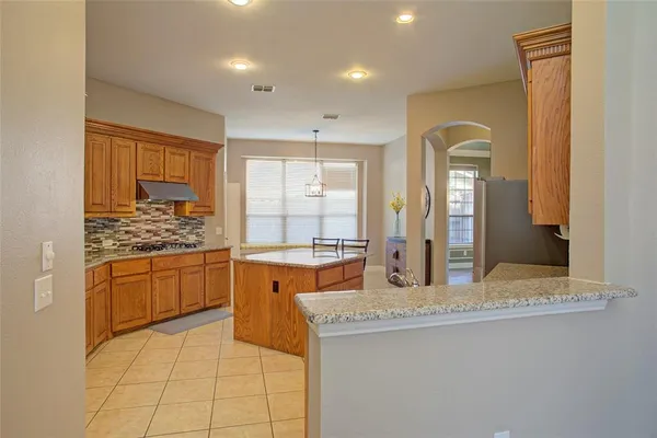 a kitchen with granite countertop sink and cabinets