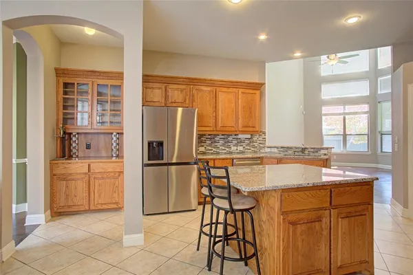 a kitchen with refrigerator a sink and cabinets