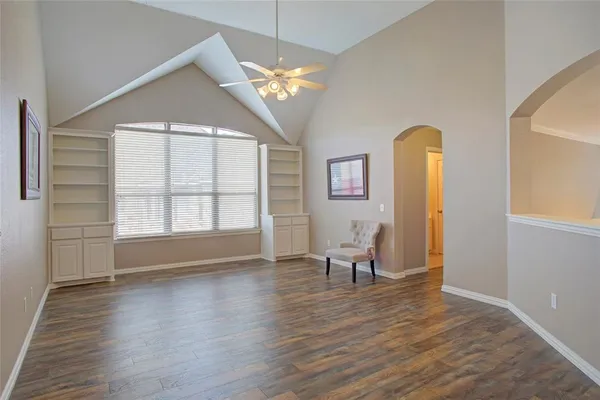 a view of a livingroom with wooden floor and a window