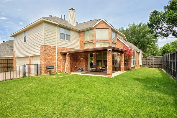 a view of a house with a yard and sitting area