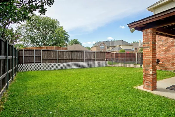 a view of a backyard with a garden and deck