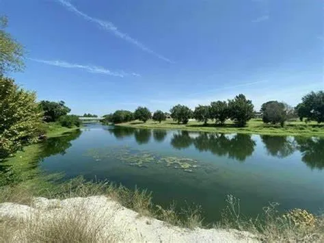 a view of a lake with houses in the back