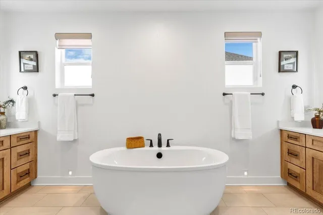 a white bath tub sitting next to a white sink