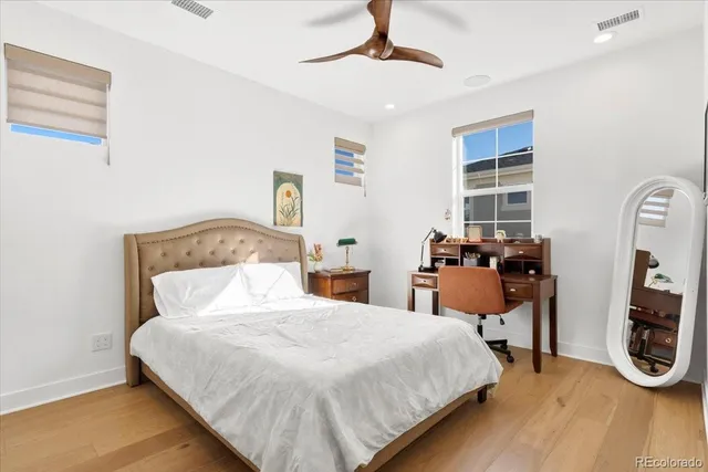 a bedroom with bed and a chandelier