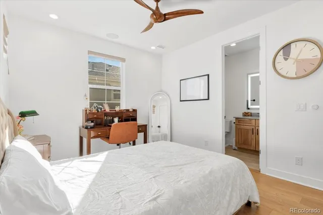 a bedroom with bed and wooden floor