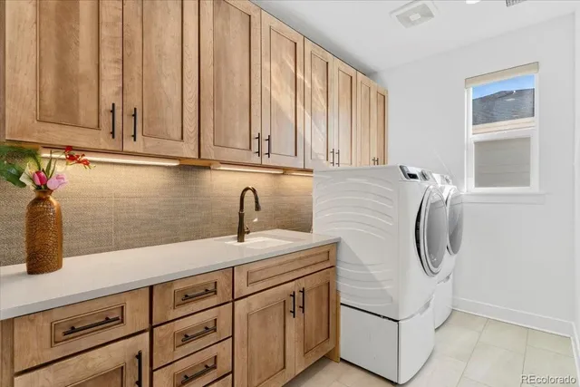 a kitchen with stainless steel appliances granite countertop a sink a refrigerator and cabinets