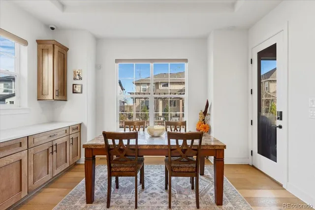 a view of a dining room with furniture and wooden floor