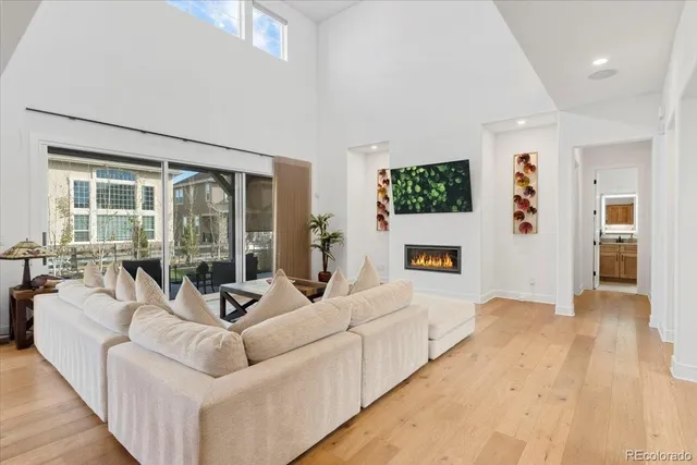 a living room with furniture mirror and a flat screen tv