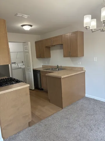 a kitchen with stainless steel appliances granite countertop a refrigerator stove and microwave