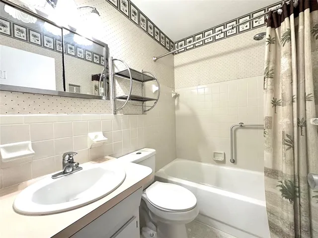 a bathroom with a sink a toilet and a bathtub