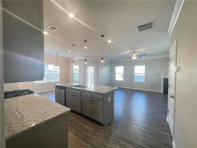 a bathroom with a granite countertop sink a large mirror and a bathtub