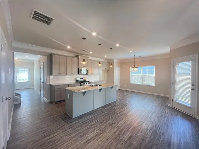 a large kitchen with lots of counter space a sink and appliances