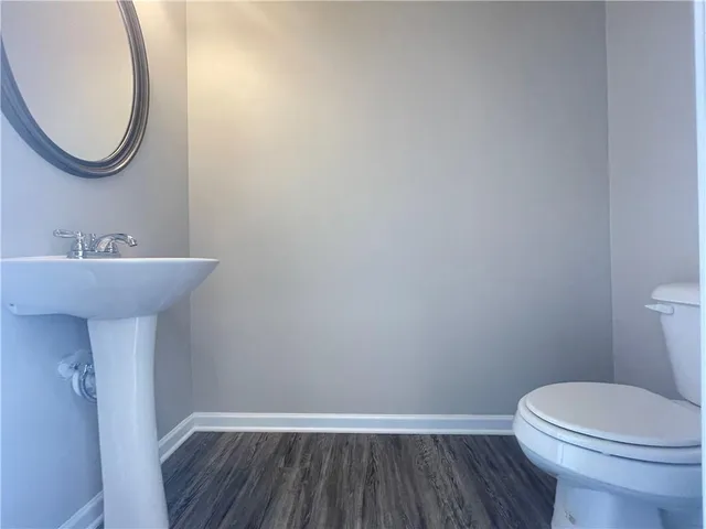 a bathroom with a sink mirror and toilet