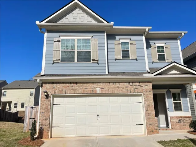 a front view of a house with a garage