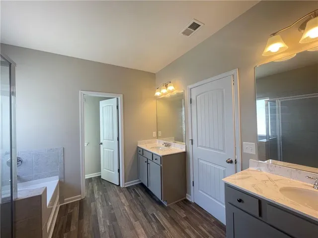 a view of a kitchen cabinets a sink and wooden floor