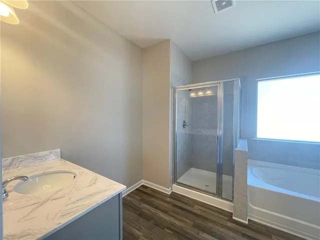 a bathroom with a tub and shower